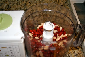 In food processor, blend the kidney beans, sweet potato, lemon juice, cilantro leaves and place in a large bowl.
