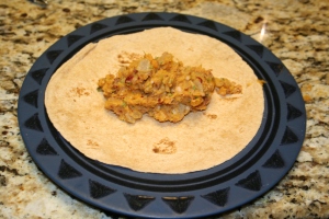 Place a small amount of the mixture in the center of a flour tortilla.