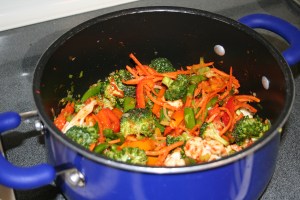 Add the red peppers, snap peas, cauliflower, broccoli, carrots and curry paste. Mix everything together and cook on medium high heat for approx 10 minutes.