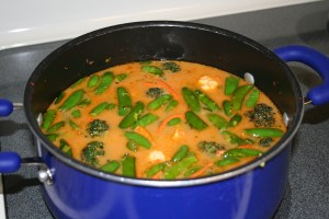 Add the almond milk, vegetable stock, water and tamari. Stir and cook on medium high until vegetables are desired tenderness - approx 30 minutes.