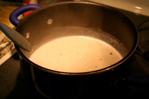 Mix the milk and flour together until they are smooth and then add to the garlic and butter. Increase heat to high cooking and stirring until it is bubbly and thickened.
