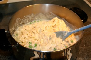 Rinse the fettuccine and return to the pot. Add the sauce to the fettuccine and mix together.