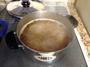 Boil the pasta in a separate pot. You'll know it's ready when you throw it against the wall and it sticks! Or you can taste it. :) Drain and rinse the pasta.